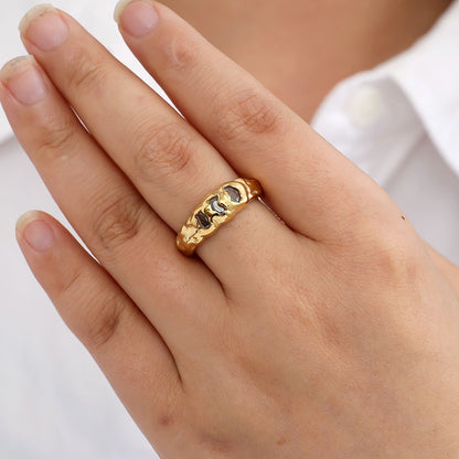 Goldener Edelstahlring mit drei funkelnden Steinen von Juwejé.